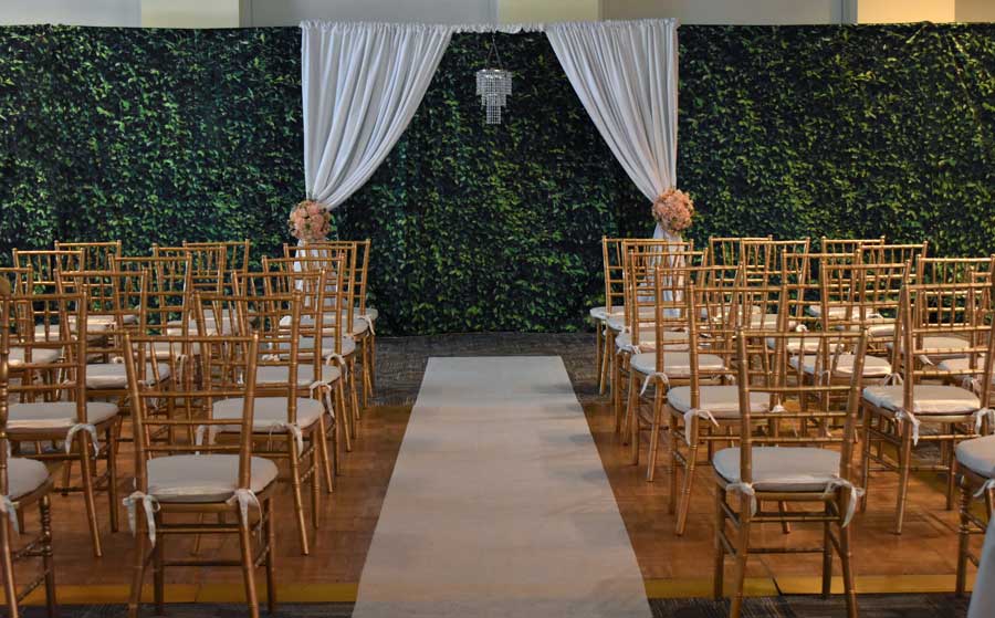 Indoor Ceremony Arch with Greenery Backdrop